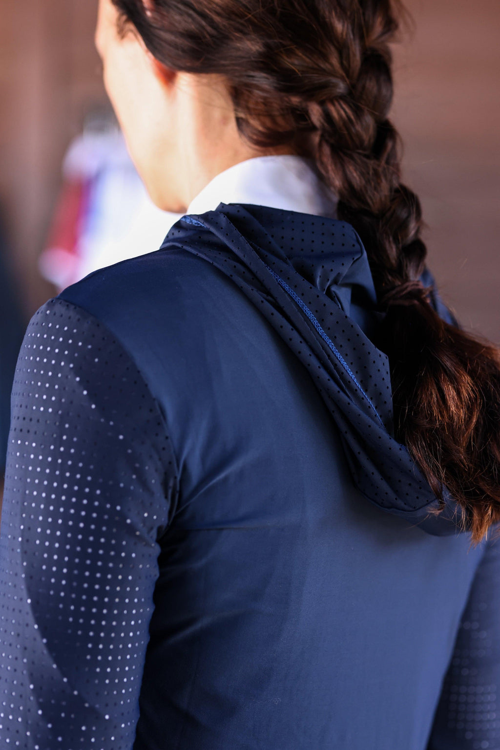 Technical perforated hoodie designed for equestrian enthusiasts, combining style and functionality seamlessly.
